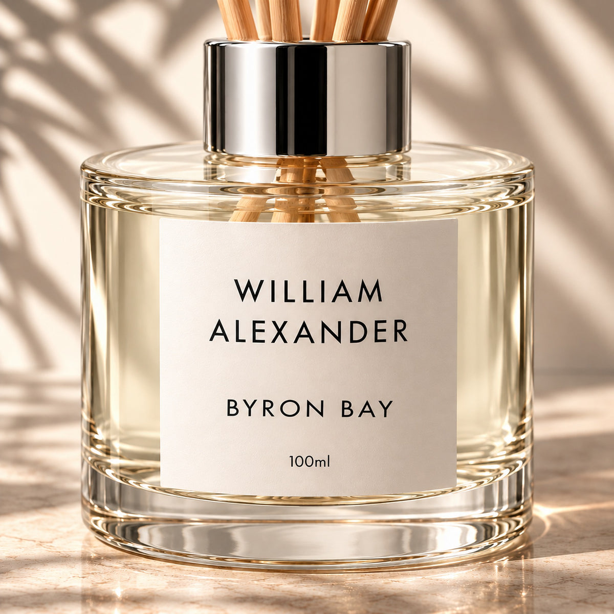 Close-up of the William Alexander Byron Bay 33 Sandalwood & Cedar reed diffuser with natural rattan reeds and silver collar