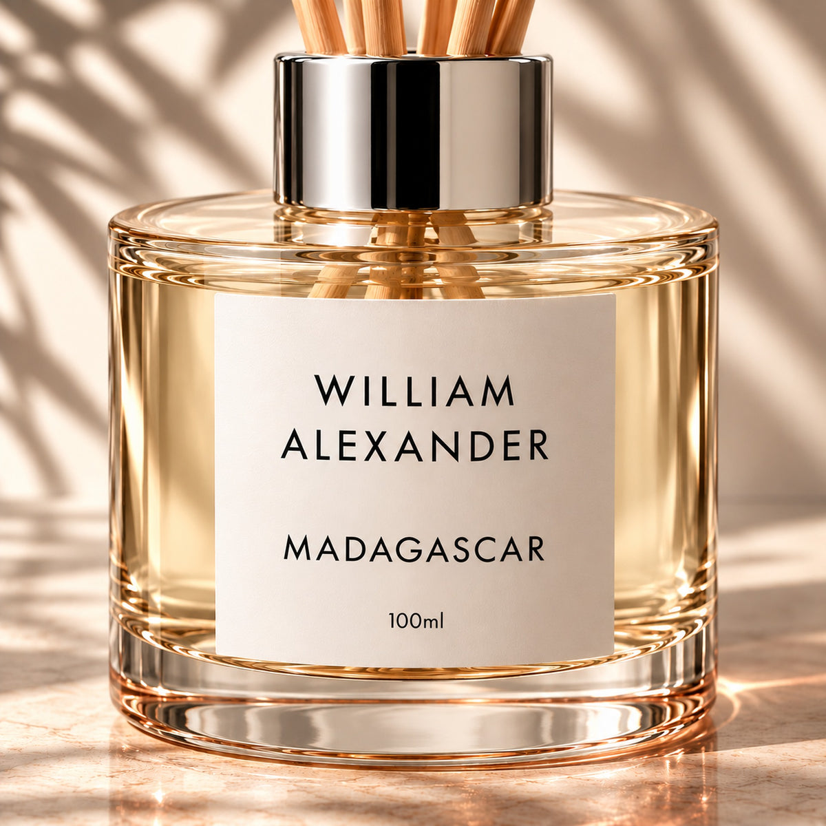 Close-up of the William Alexander Madagascar Vanilla & Amber reed diffuser with natural rattan reeds and silver collar